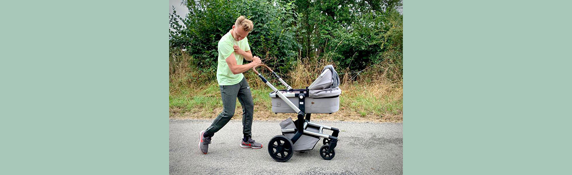 Sterke vader achter kinderwagen